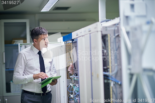 Image of network engineer working in  server room