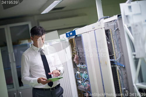 Image of network engineer working in  server room