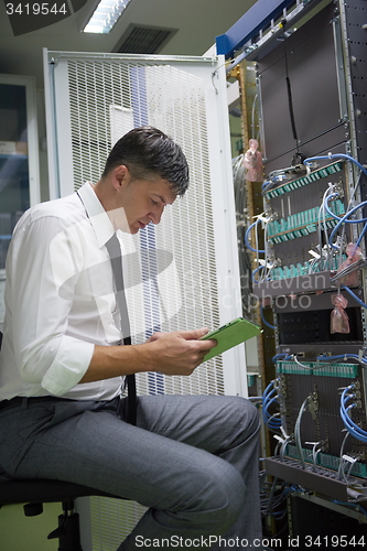 Image of network engineer working in  server room