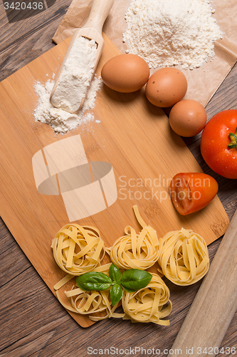 Image of Raw pasta, tomato and eggs