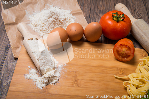 Image of Raw pasta, tomato and eggs