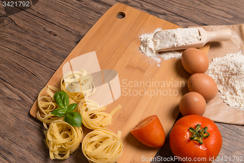 Image of Raw pasta, tomato and eggs