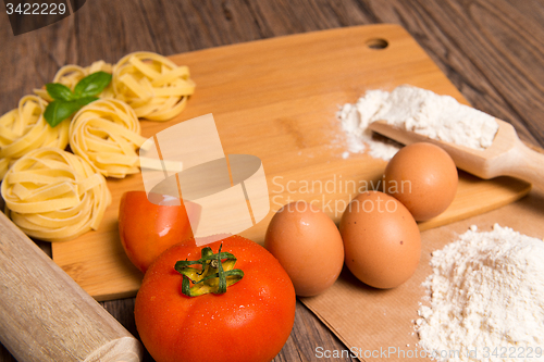 Image of Raw pasta, tomato and eggs