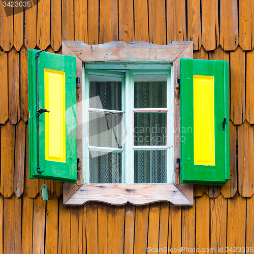 Image of Colorful vintage wooden window shutters.