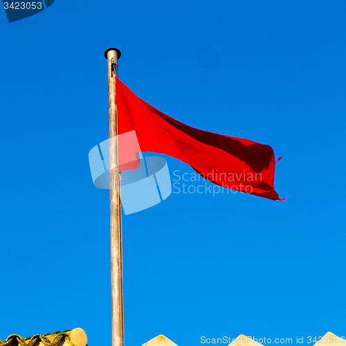 Image of tunisia  waving flag in the blue sky  colour and battlements  wa