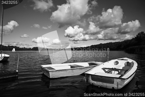 Image of Colorful boats on a lake with cloudy blue sky in Denmark