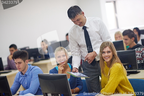 Image of students with teacher  in computer lab classrom