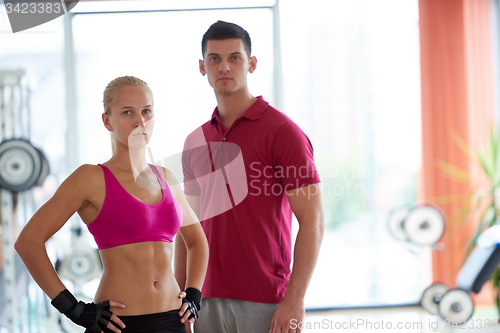 Image of young sporty woman with trainer exercise weights lifting