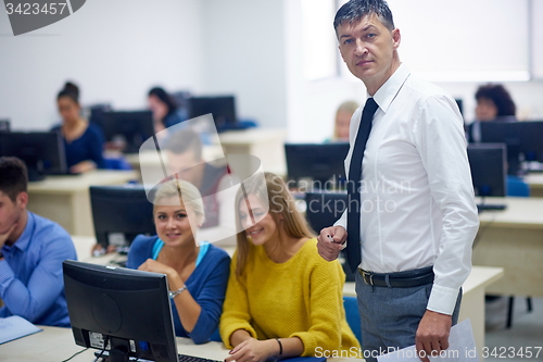 Image of students with teacher  in computer lab classrom