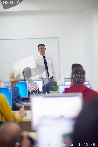 Image of students with teacher  in computer lab classrom