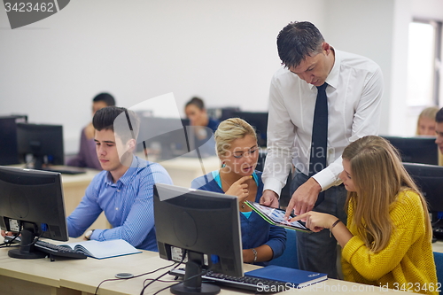 Image of students with teacher  in computer lab classrom