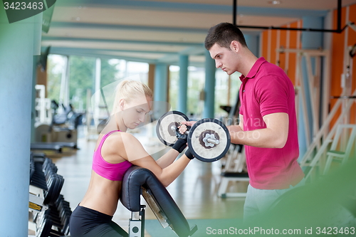Image of young sporty woman with trainer exercise weights lifting