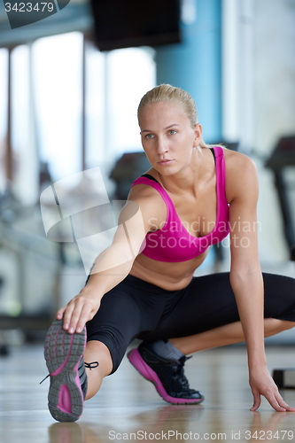 Image of woman stretching and warming up for her training at a gym