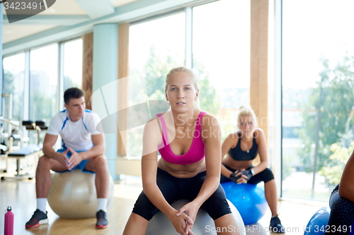 Image of group of people exercise with balls on yoga class