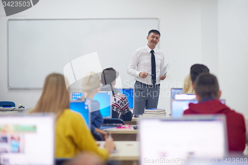 Image of students with teacher  in computer lab classrom