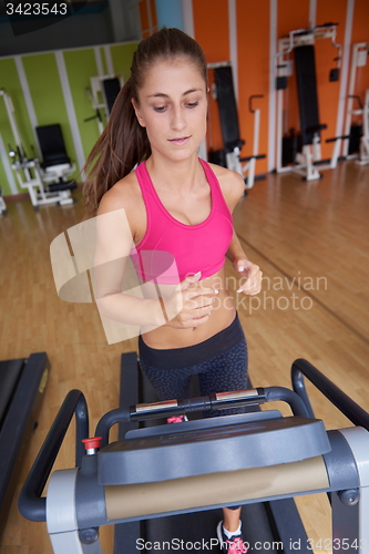 Image of woman exercising on treadmill in gym