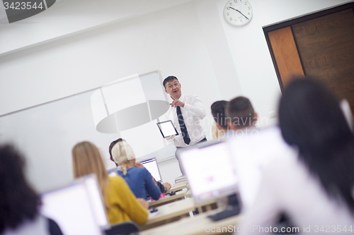 Image of students with teacher  in computer lab classrom