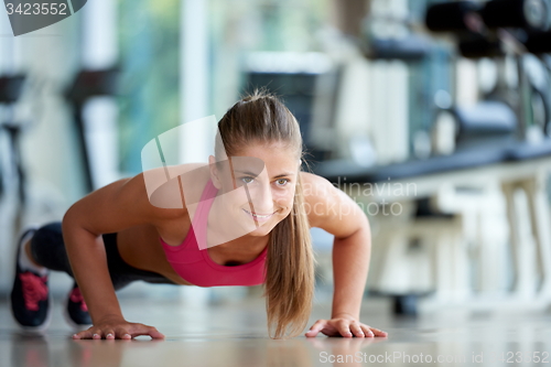 Image of warming up and doing some push ups a the gym