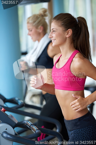 Image of woman exercising on treadmill in gym