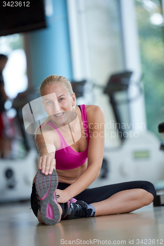 Image of woman stretching and warming up for her training at a gym