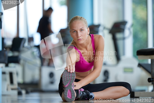 Image of woman stretching and warming up for her training at a gym