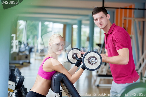Image of young sporty woman with trainer exercise weights lifting