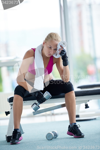 Image of young woman exercise with dumbells