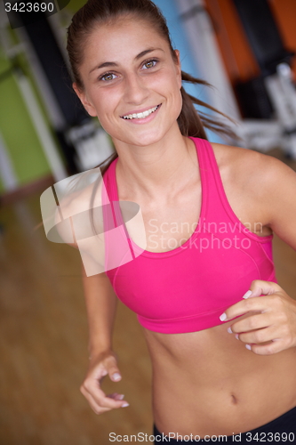 Image of woman exercising on treadmill in gym