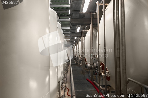 Image of Large industrial white silos in modern factory