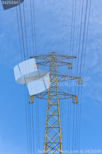 Image of Large electric pylon with blue sky