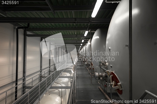 Image of Large industrial white silos in modern factory