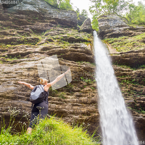 Image of Active sporty woman relaxing in beautiful nature.