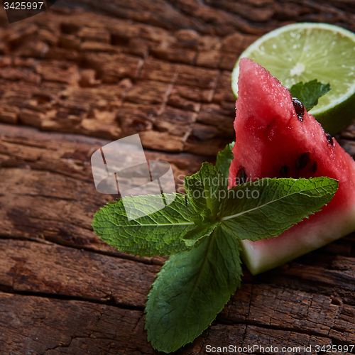 Image of Watermelon, mint and lime on the wooden background