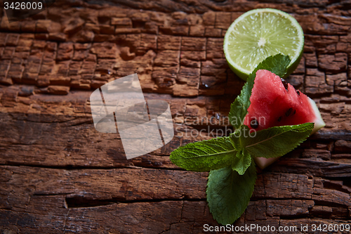 Image of Watermelon, mint and lime on the wooden background