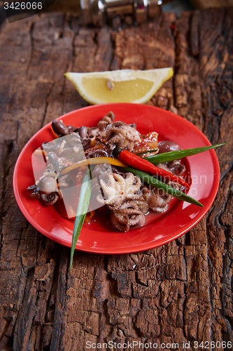 Image of Baby octopuses in red dish