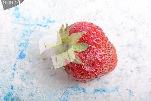 Image of Close up of strawberry with green leaves