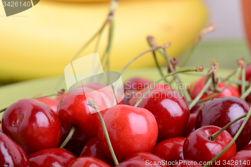 Image of Close up of a fresh pile of fruit consisting of cherries and bananas