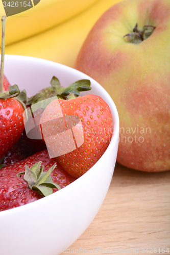 Image of Close-up shot of variety of fruits on old wooden plate