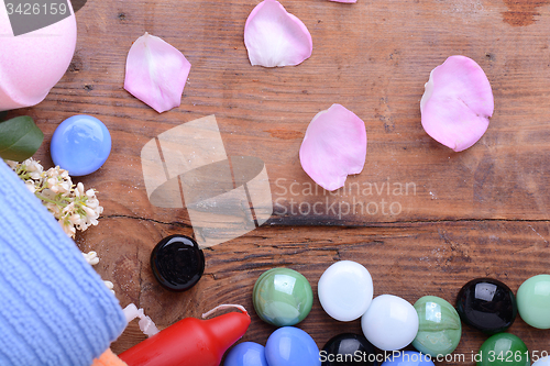 Image of Spa composition with towels set, candles, flower petals, stones