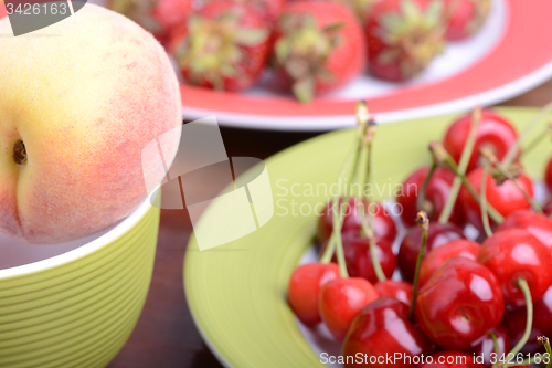 Image of fresh fruits and berries mixed collection surface close up, summer health food, peach, cherry, strawberry.