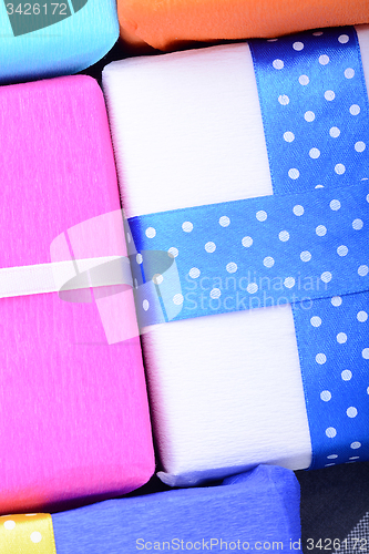 Image of bright gifts with ribbons, holiday invitation card