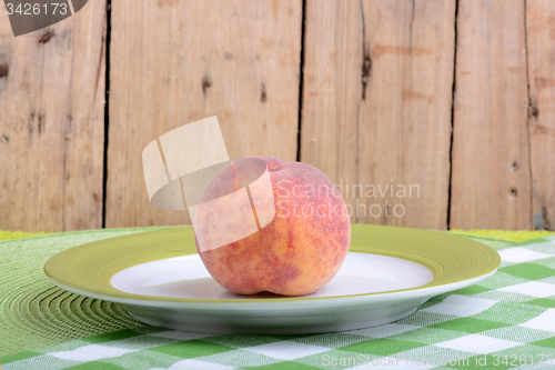 Image of fresh peaches on green plate, food concept