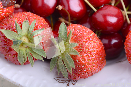 Image of Background from fresh ripe strawberries and cherry