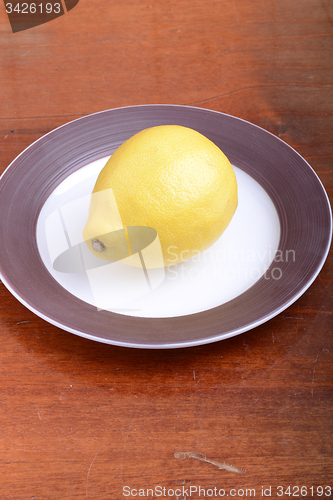 Image of fresh lemon on grey plate