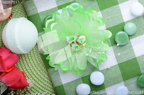 Image of Spa stones, flower sea salt  on green and white towel