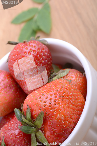 Image of Close up strawberry on wooden plate