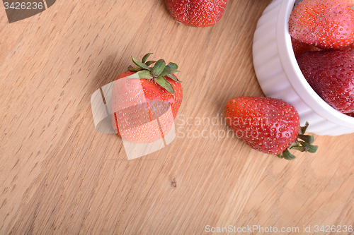 Image of close up of big strawberry on wood