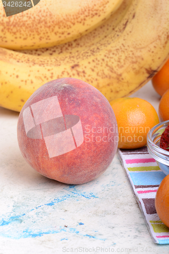 Image of many different fruits for the health of the entire family, peach, mandarin, orange, banana