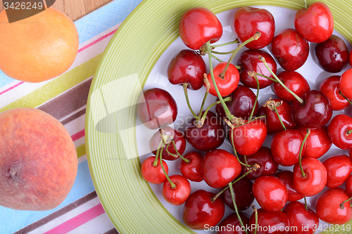 Image of mandarin, peach and cherry fresh fruits and berries, summer health food, top view