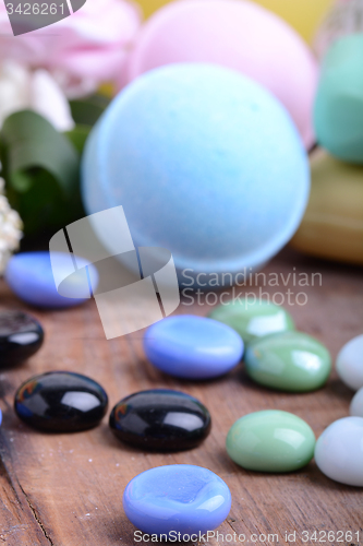 Image of Beautiful spa setting with stone set, soap and sea salt on wooden table close up